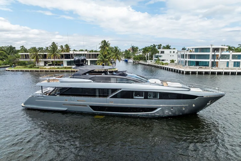 The Image of Luxury 2022 Riva 110' Dolcevita yacht cruising in a scenic waterfront setting. - 0