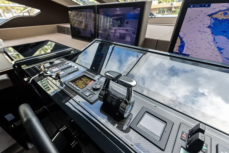 Slide: The Image of Control panel of 2022 Riva 110' Dolcevita yacht with navigation screens and controls. - 32