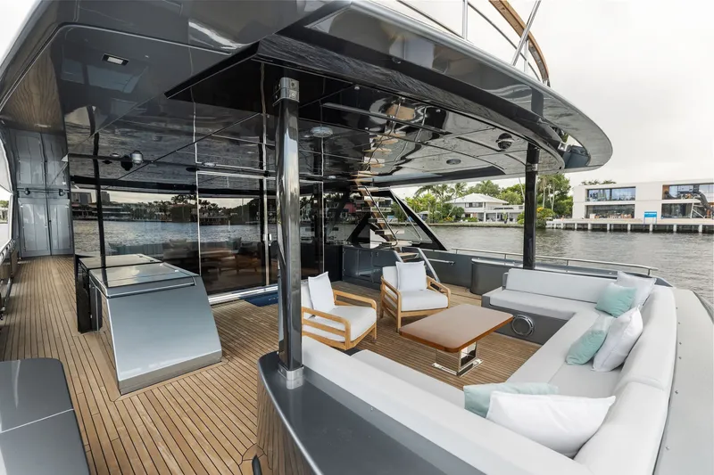 Slide: The Image of Luxurious 2022 Riva 110' Dolcevita yacht deck with modern seating and scenic waterfront view. - 21