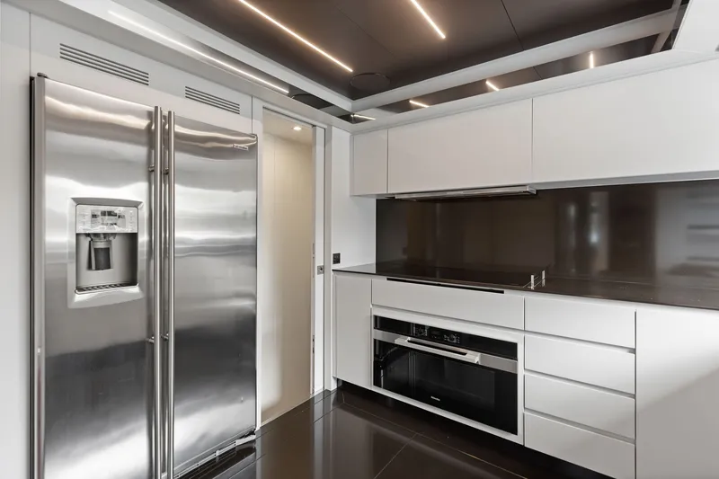 Slide: The Image of Modern kitchen interior on 2022 Riva 110' Dolcevita yacht with sleek appliances and cabinetry. - 34