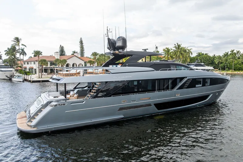 Slide: The Image of 2022 Riva 110' Dolcevita luxury yacht docked in a scenic waterfront setting. - 3