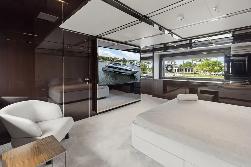 Slide: The Image of Luxurious interior of 2022 Riva 110' Dolcevita yacht with modern furnishings and large window view. - 40