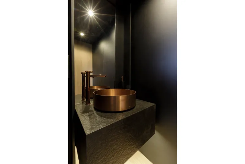 Slide: The Image of Luxurious bathroom with copper sink and modern fixtures on Mangusta GranSport 33 yacht, 2024 model. - 26