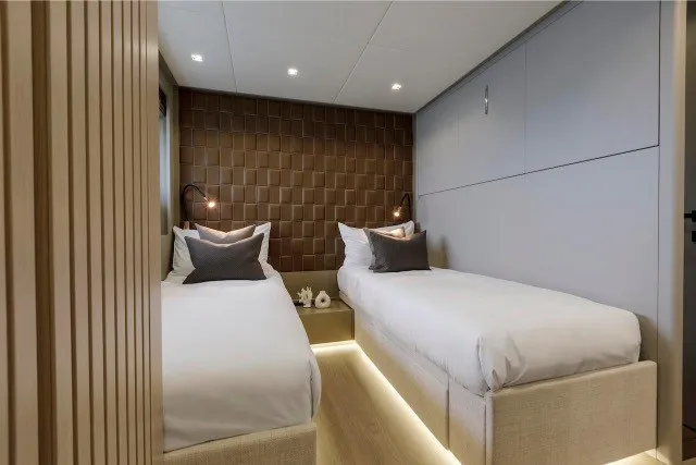 Slide: The Image of Luxurious twin bedroom in 2024 Mangusta GranSport 33 yacht, featuring modern design and ambient lighting. - 30