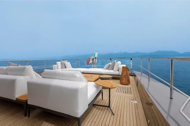 Slide: The Image of Luxurious deck of 2024 Mangusta GranSport 33 yacht with white seating and ocean view. - 39