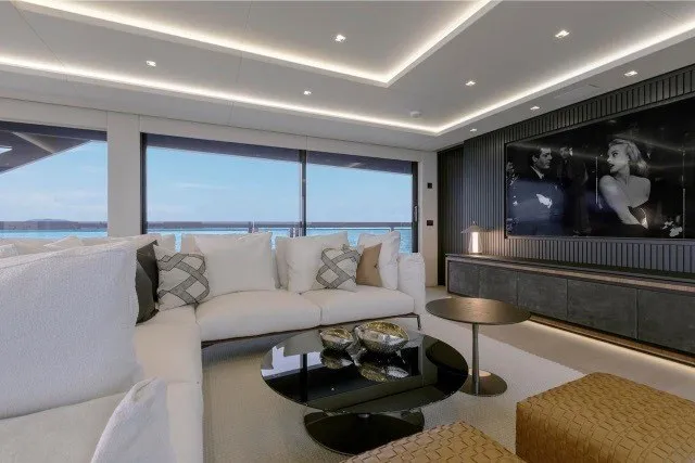 Slide: The Image of Luxurious interior of 2024 Mangusta GranSport 33 yacht with elegant seating and large windows. - 16