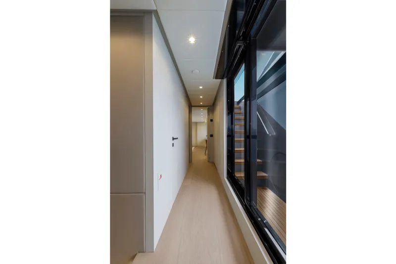 Slide: The Image of 2024 Mangusta GranSport 33 yacht interior hallway with modern design and sleek finishes. - 25