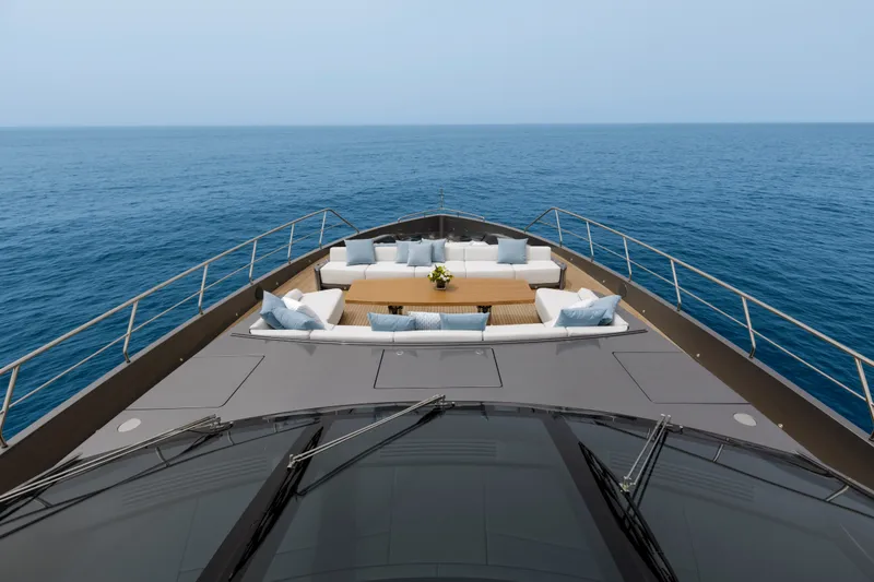 Slide: The Image of Luxurious 2024 Mangusta GranSport 33 yacht deck with elegant seating, overlooking the ocean. - 60