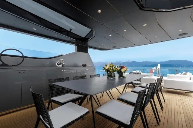 Slide: The Image of Luxurious 2024 Mangusta GranSport 33 yacht deck with elegant dining area and ocean view. - 35