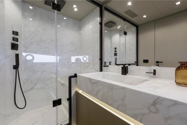 Slide: The Image of Luxurious marble bathroom in 2024 Mangusta GranSport 33 yacht, featuring modern fixtures and elegant design. - 29