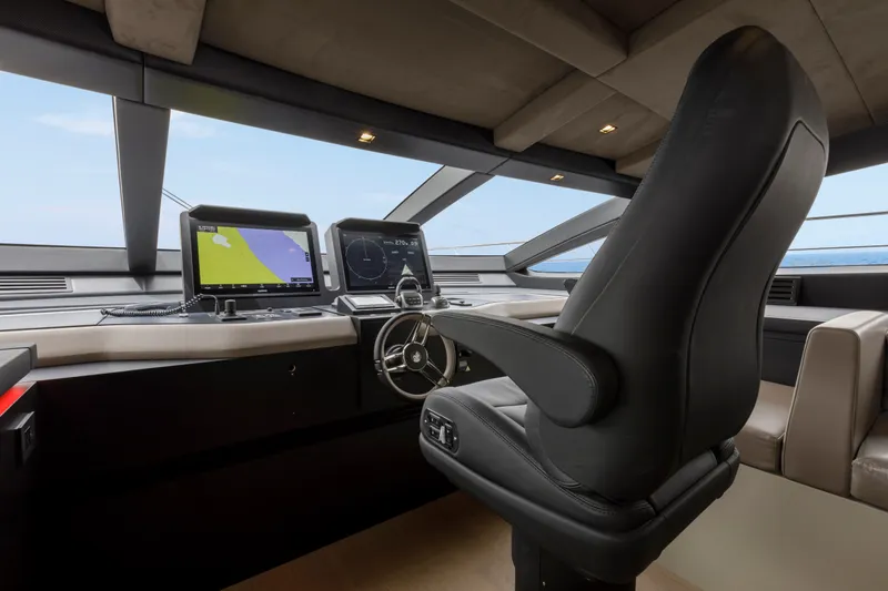 Slide: The Image of 2024 Mangusta GranSport 33 yacht cockpit with navigation screens and captain's chair. - 38