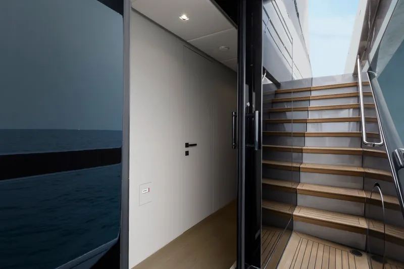 Slide: The Image of 2024 Mangusta GranSport 33 yacht interior with modern staircase and sleek design. - 20