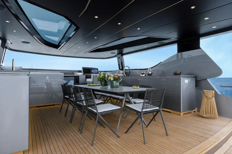 Slide: The Image of Luxurious 2024 Mangusta GranSport 33 yacht interior with elegant dining area and ocean view. - 56