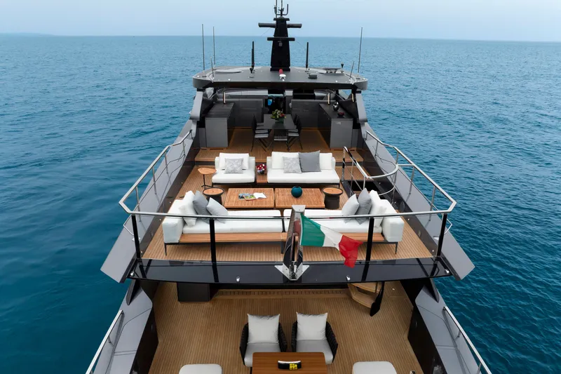Slide: The Image of 2024 Mangusta GranSport 33 yacht with luxurious deck seating on open sea. - 14