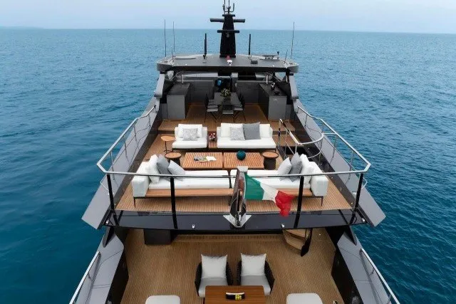 Slide: The Image of 2024 Mangusta GranSport 33 yacht with luxurious deck, ocean view, and elegant seating arrangement. - 38
