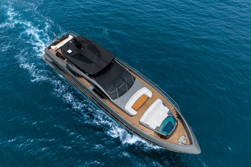 Slide: The Image of 2024 Mangusta GranSport 33 yacht cruising on open blue sea, aerial view. - 6