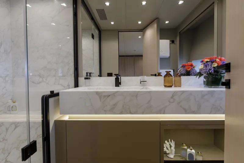 Slide: The Image of Luxurious bathroom interior of 2024 Mangusta GranSport 33 yacht with marble sink and floral decor. - 46