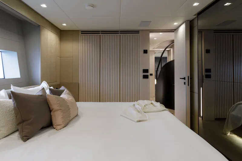 Slide: The Image of Luxurious bedroom interior of 2024 Mangusta GranSport 33 yacht, featuring elegant design and soft lighting. - 45
