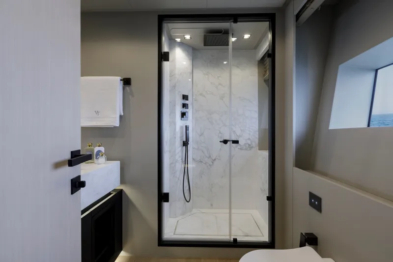 Slide: The Image of Luxurious bathroom in 2024 Mangusta GranSport 33 yacht with marble shower and modern fixtures. - 53