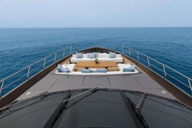 Slide: The Image of 2024 Mangusta GranSport 33 yacht deck with luxurious seating, overlooking the ocean. - 41
