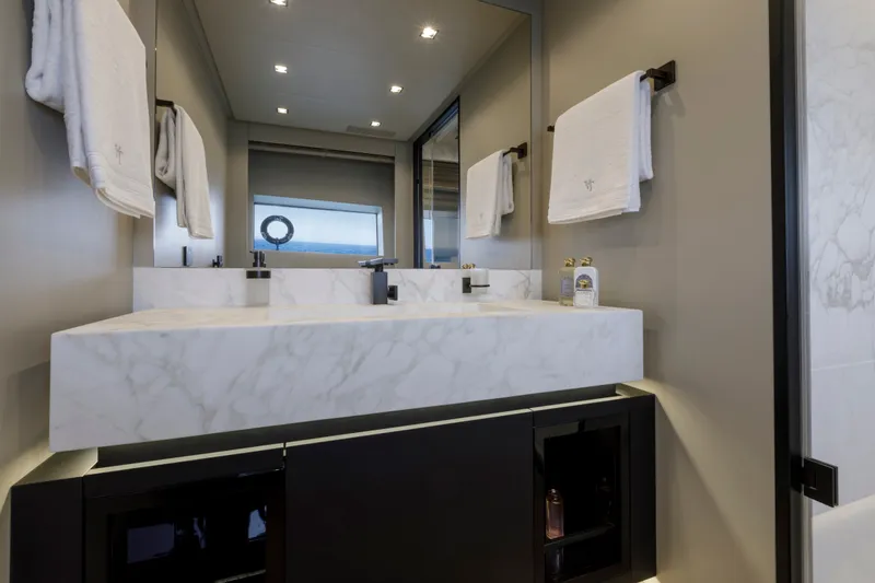 Slide: The Image of Luxurious bathroom in 2024 Mangusta GranSport 33 yacht with marble sink and elegant fixtures. - 54