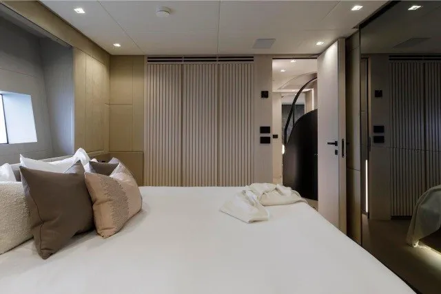 Slide: The Image of Luxurious bedroom interior of 2024 Mangusta GranSport 33 yacht, featuring elegant design and plush bedding. - 25
