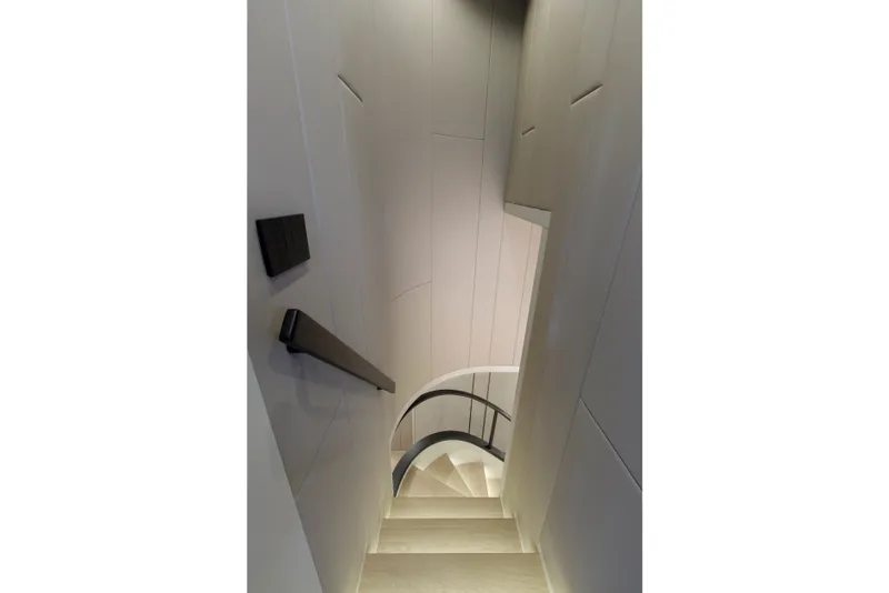 Slide: The Image of Elegant interior staircase of 2024 Mangusta GranSport 33 yacht, featuring sleek design and modern lighting. - 40