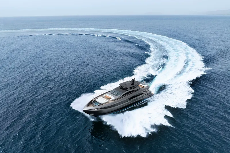 Slide: The Image of 2024 Mangusta GranSport 33 yacht cruising swiftly on open sea. - 4