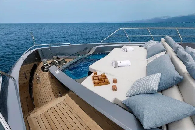 Slide: The Image of Luxurious 2024 Mangusta GranSport 33 yacht deck with plush seating and ocean view. - 42