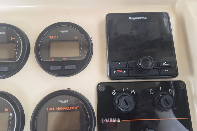 Slide: The Image of Yamaha gauges and Raymarine display on 2006 Rosborough RF-246 boat dashboard. - 8
