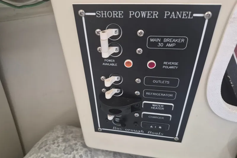 Slide: The Image of Shore power panel on 2006 Rosborough RF-246 boat, featuring main breaker and various switches. - 15
