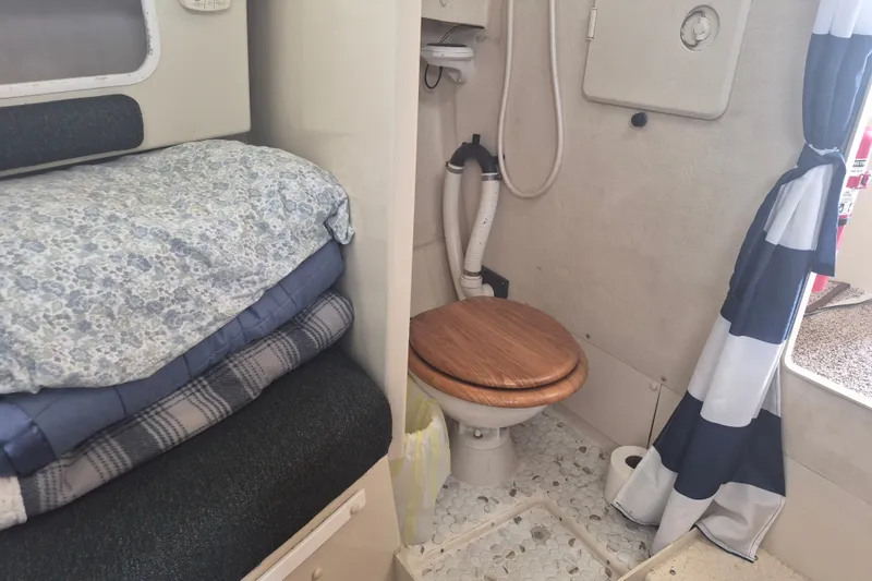 Slide: The Image of 2006 Rosborough RF-246 interior with compact bathroom and cozy bedding area. - 14