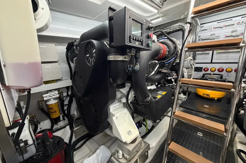 Slide: The Image of Engine room of a 2020 Horizon E56 yacht, featuring advanced machinery and control systems. - 98