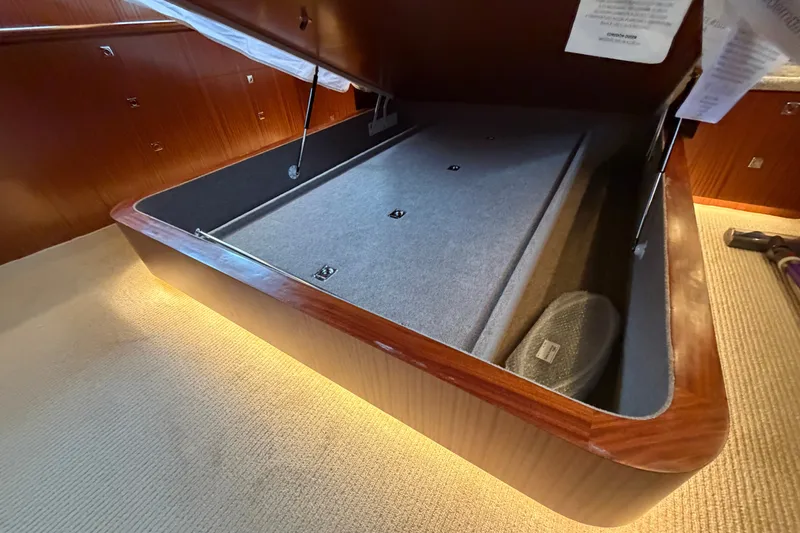 Slide: The Image of Open storage compartment in 2020 Horizon E56 yacht, featuring wood finish and carpeted interior. - 71