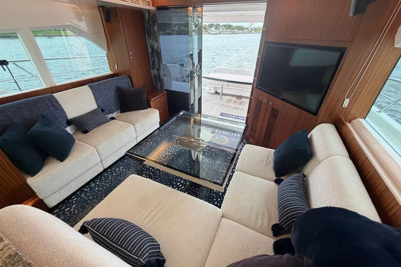 Slide: The Image of Luxurious interior of 2020 Horizon E56 yacht with plush seating and waterfront view. - 40