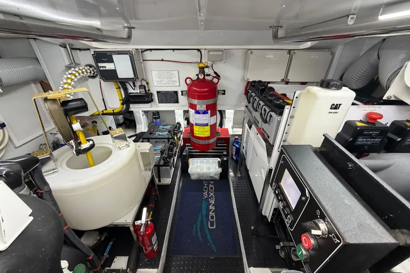 Slide: The Image of Engine room of 2020 Horizon E56 yacht with fire extinguisher and control panels. - 89