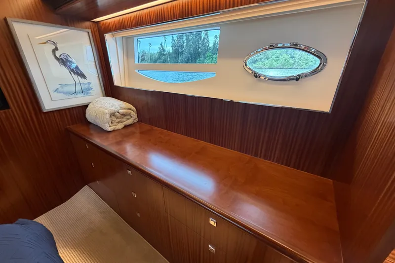 Slide: The Image of Luxurious Horizon E56 yacht interior with wood finish, window view, and heron artwork. - 53