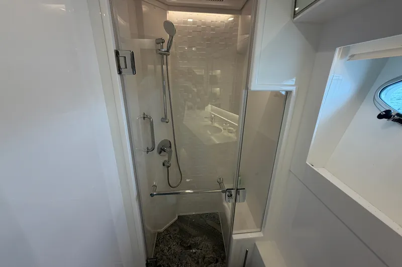 Slide: The Image of Modern shower area in 2020 Horizon E56 yacht, featuring sleek design and glass door. - 67