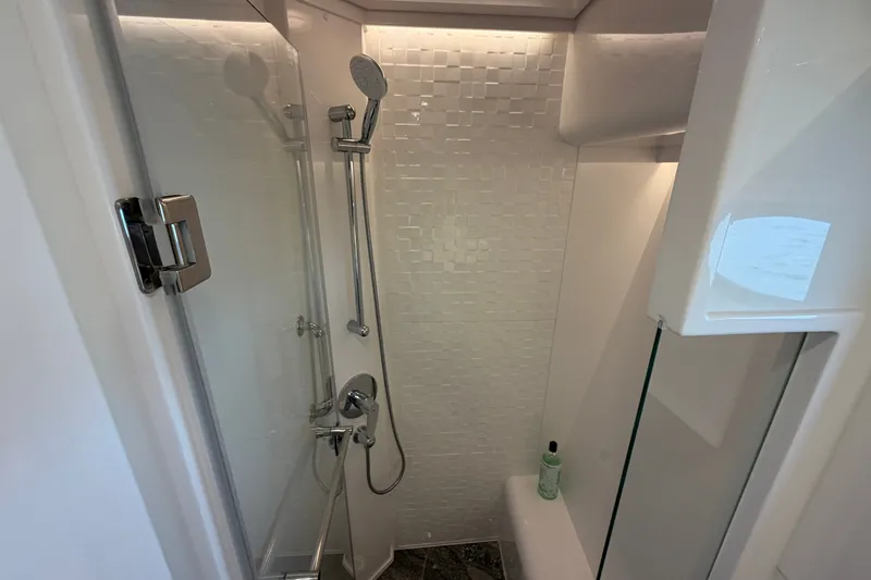 Slide: The Image of Modern shower in 2020 Horizon E56 yacht, featuring sleek design and white tiled walls. - 68