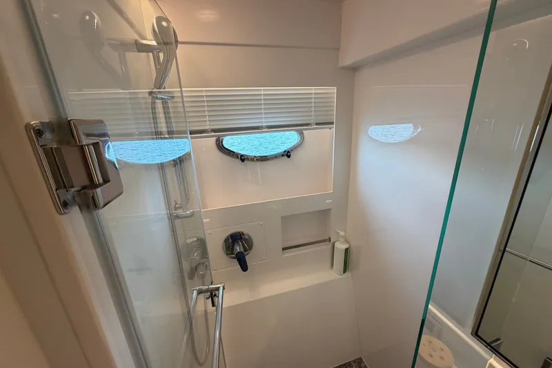 Slide: The Image of Modern shower area in 2020 Horizon E56 yacht with porthole and glass door. - 61