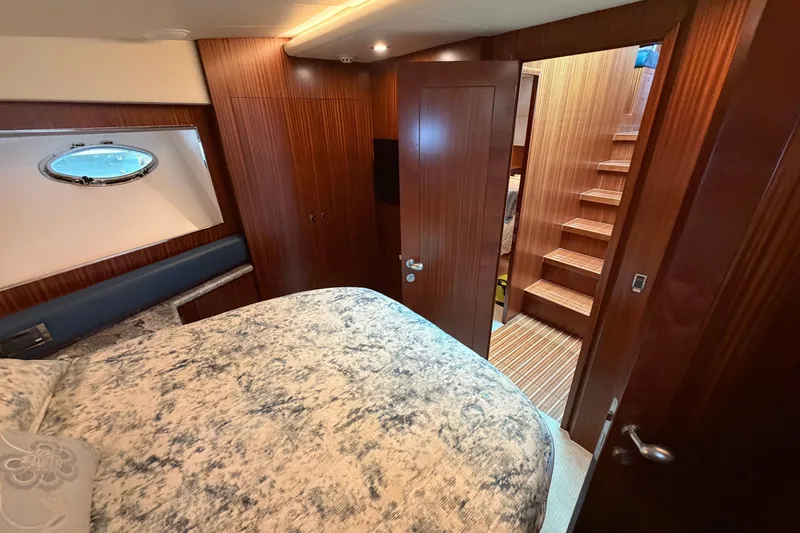 Slide: The Image of Luxurious cabin interior of 2020 Horizon E56 yacht with wooden finishes and cozy bedding. - 77