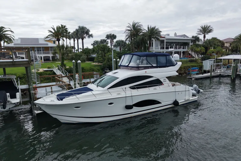 Slide: The Image of Luxury Horizon E56 yacht docked near waterfront homes, 2020 model. - 14