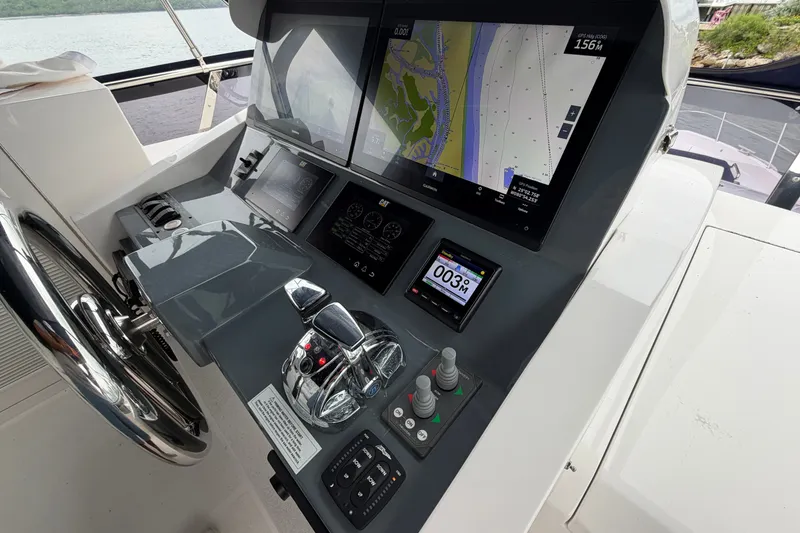 Slide: The Image of Helm of 2020 Horizon E56 yacht with navigation screens and controls. - 86