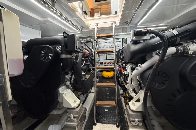 Slide: The Image of Engine room of a 2020 Horizon E56 yacht, showcasing dual engines and control systems. - 96