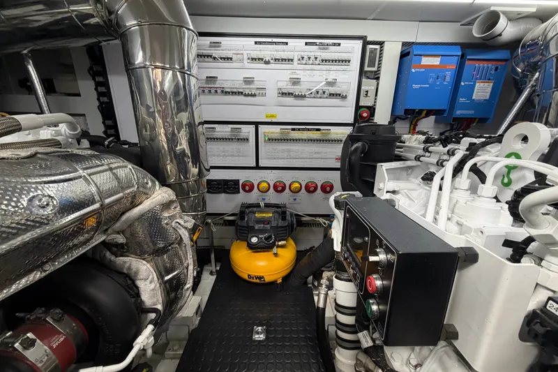 Slide: The Image of Engine room of a 2020 Horizon E56 yacht, featuring control panels and machinery. - 99