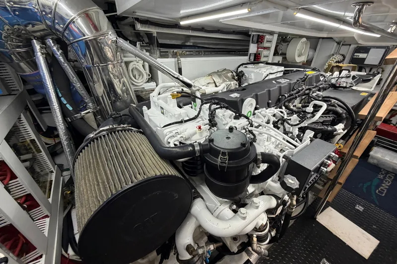Slide: The Image of Engine room of a 2020 Horizon E56 yacht, showcasing complex machinery and components. - 102