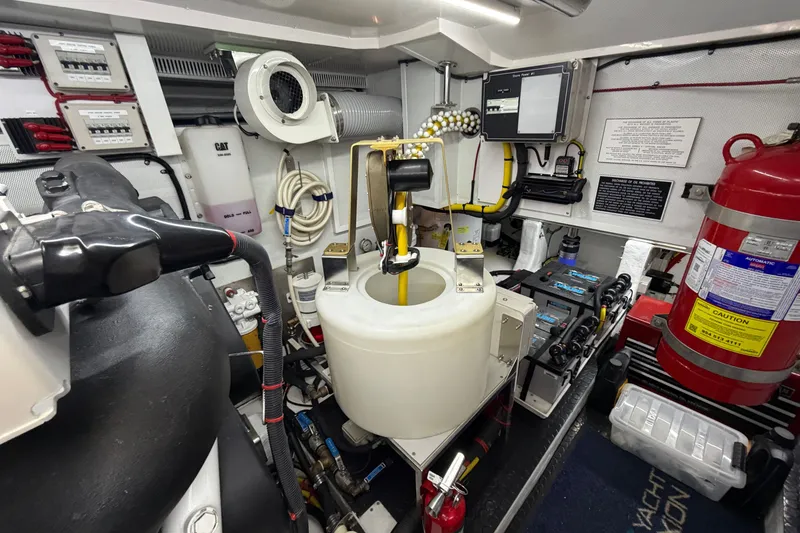 Slide: The Image of Engine room of 2020 Horizon E56 yacht with fire extinguisher and control panels. - 90