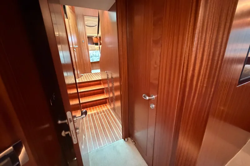 Slide: The Image of Luxurious wooden interior of 2020 Horizon E56 yacht, featuring elegant doors and stairs. - 57