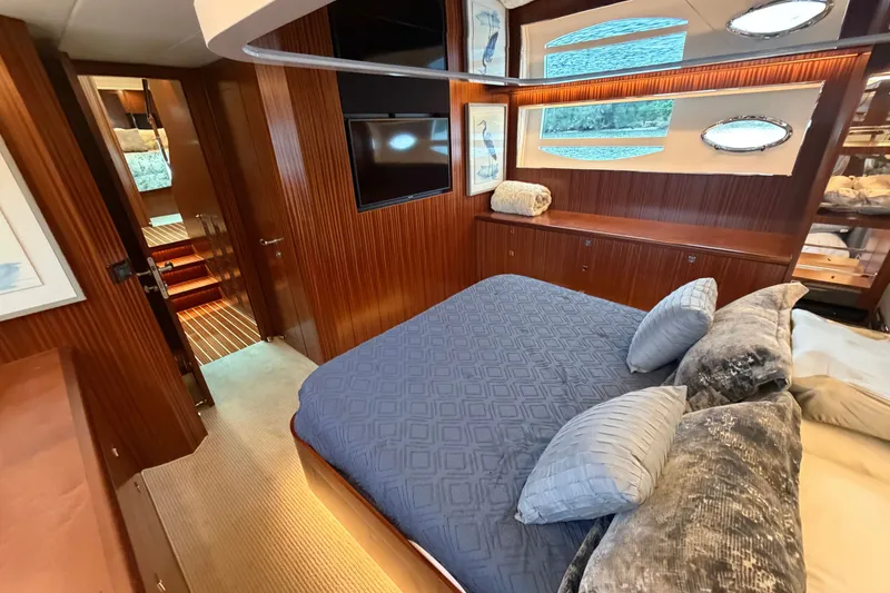Slide: The Image of Luxurious 2020 Horizon E56 yacht bedroom with elegant wood paneling and plush bedding. - 54