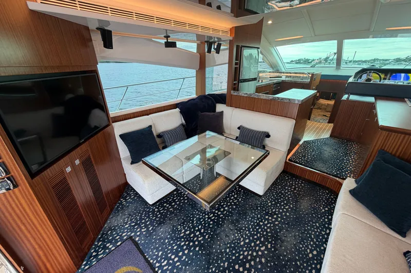Slide: The Image of Luxurious interior of 2020 Horizon E56 yacht with elegant seating and panoramic windows. - 27